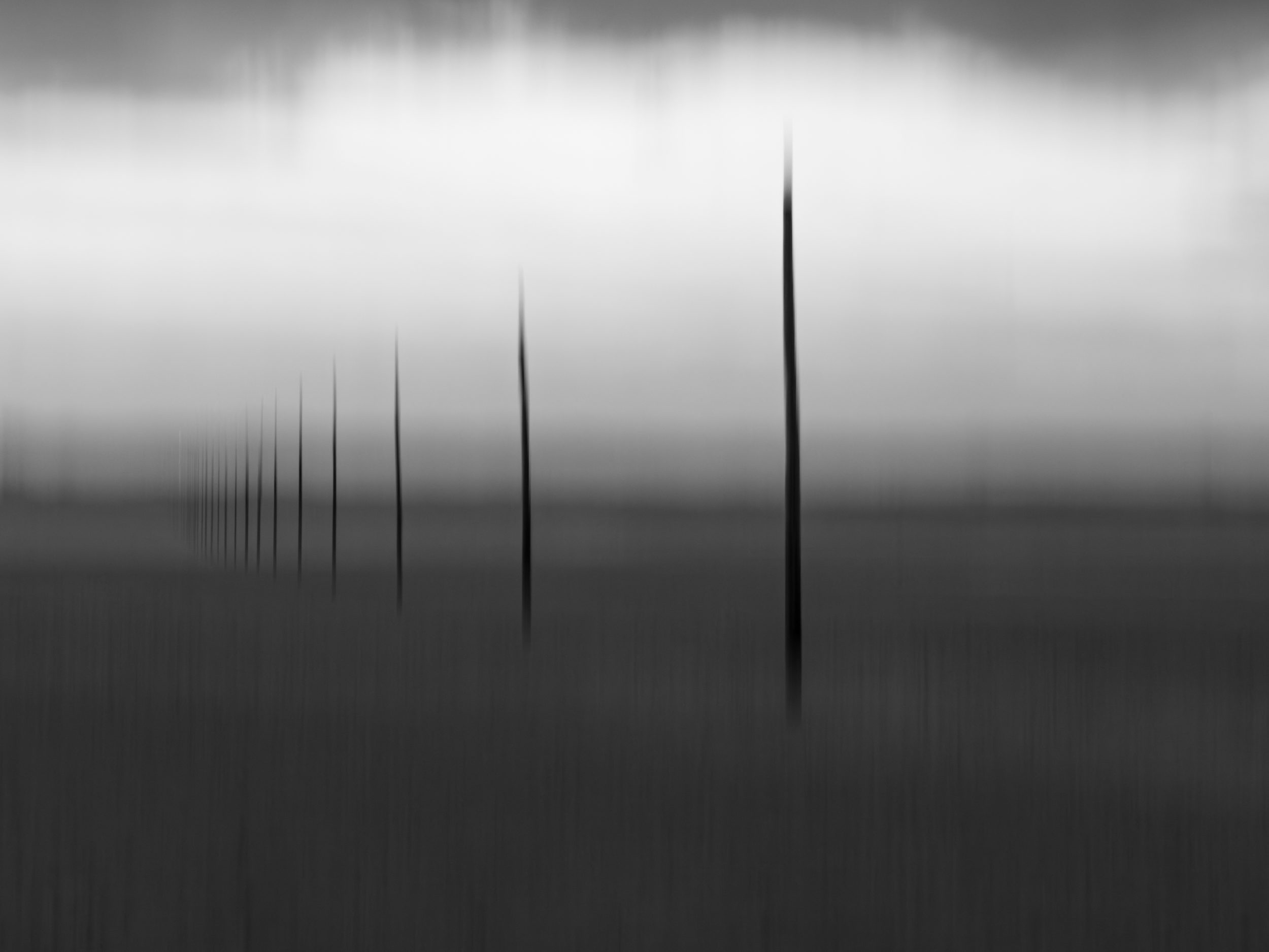Intentional camera movement ICM image of St Cuthbert's Causeway in Northumberland. Black and White,